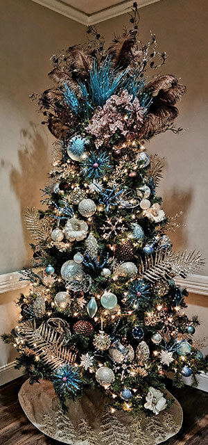 Christmas tree decorated with feathers and frosted blue and silver ornaments